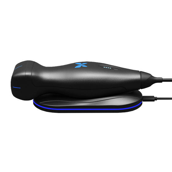 Black ultrasound device with blue butterfly logo attached to a charger on a white background